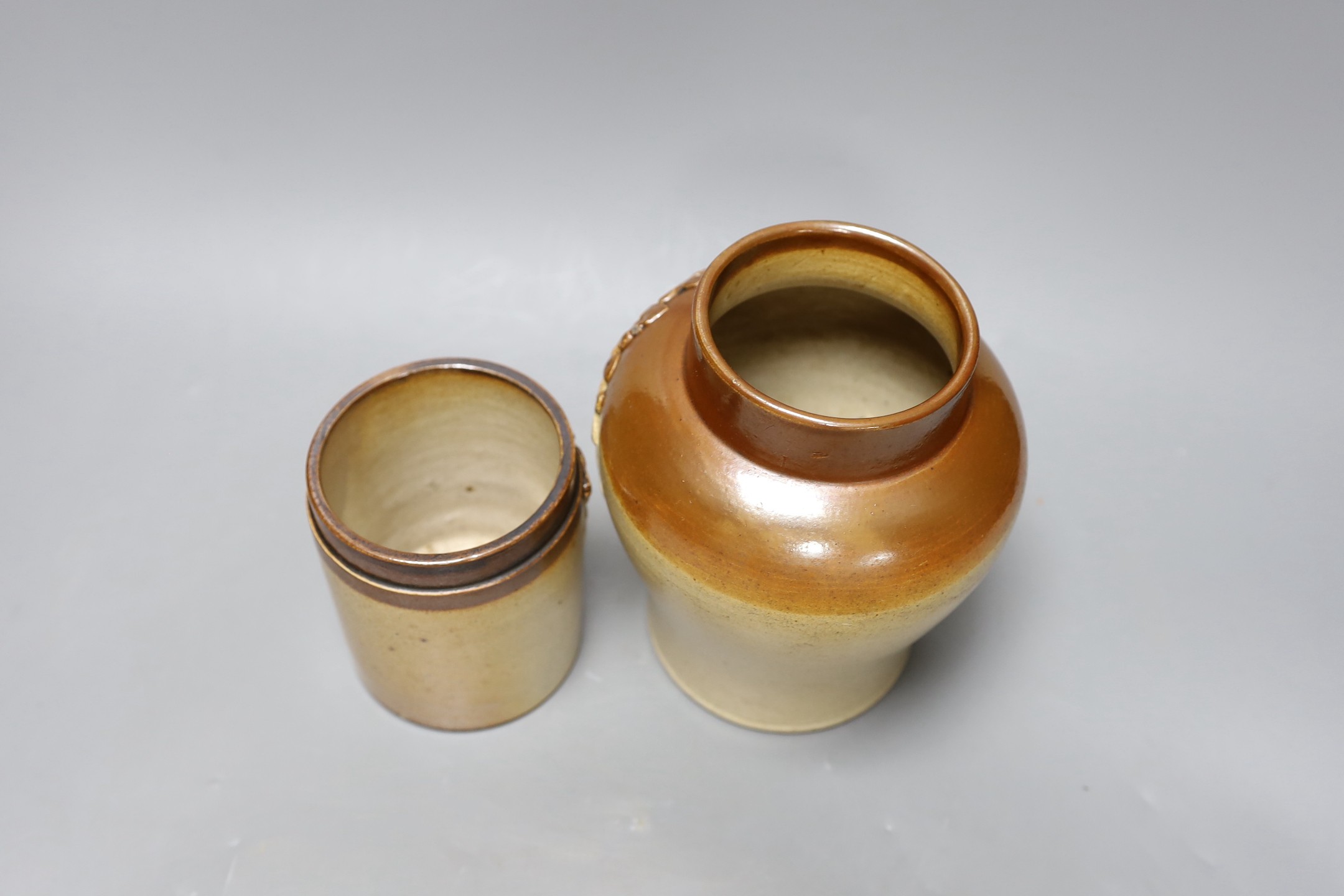 Two 19th century salt glazed stoneware storage jars, with Royal coat of arms sprigging, Tallest 18cm high